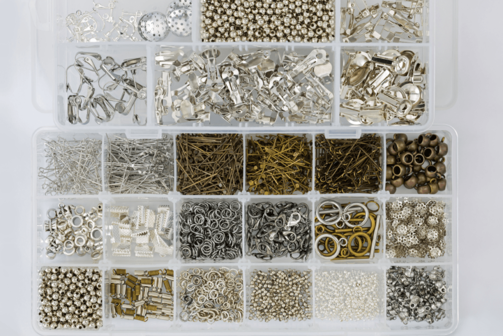 Image of a jewelry designer’s supplies including beads, hooks, and earring backs.