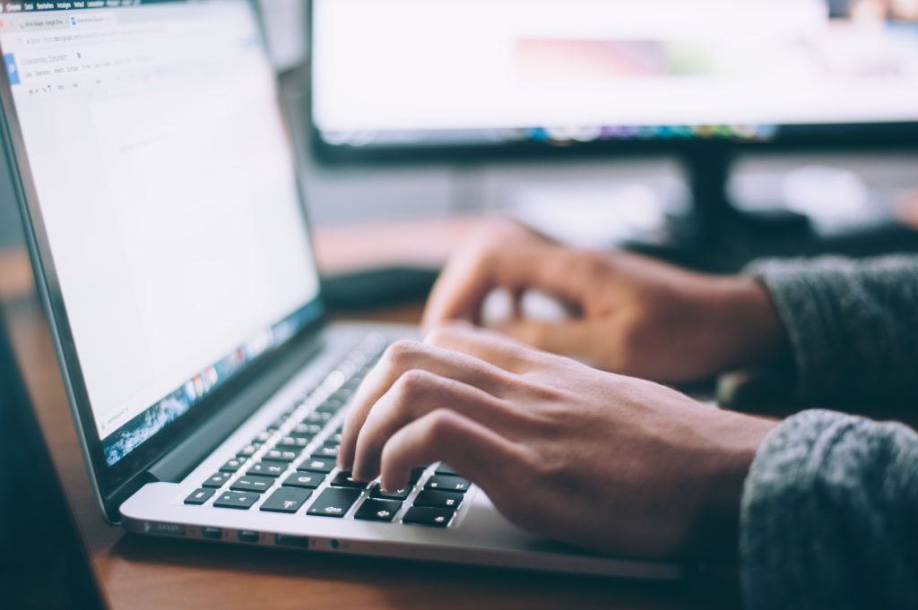 Image of a jewelry designer on a laptop securing the brand name copyright