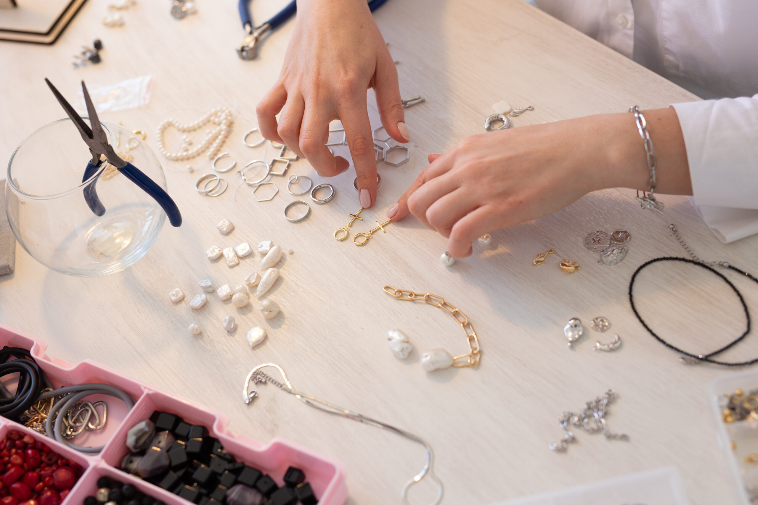 Professional jewelry designer making handmade jewelry in studio workshop close up. Fashion, creativity and handmade concept Professional jewelry designer making handmade jewelry in studio workshop. Fashion, creativity and handmade concept.